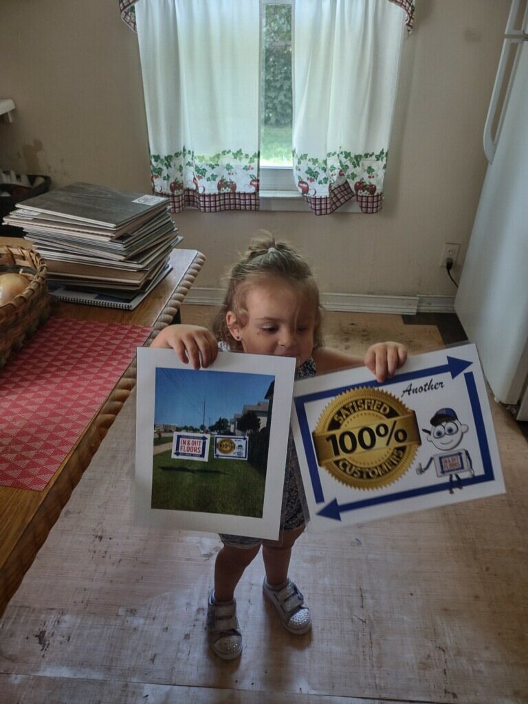 Young helper holding a 100% satisfied customer sign
