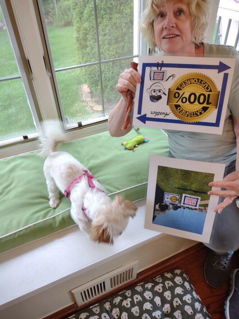 Deck Last customer and her dog displaying a 100% satisfied customer sign