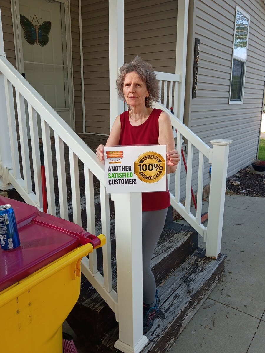 Deck Last customer standing by her porch with a 100% satisfied customer sign